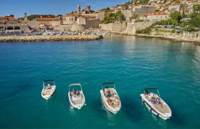 Group boat tours Dubrovnik — aerial view of Garitransfer speedboats in turquoise water near Old Town